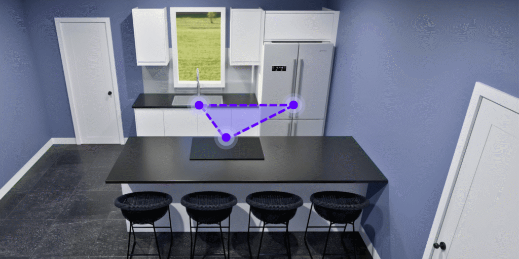 Compact single-wall kitchen with a sink, cooktop on the island, and fridge, connected by a tight work triangle.